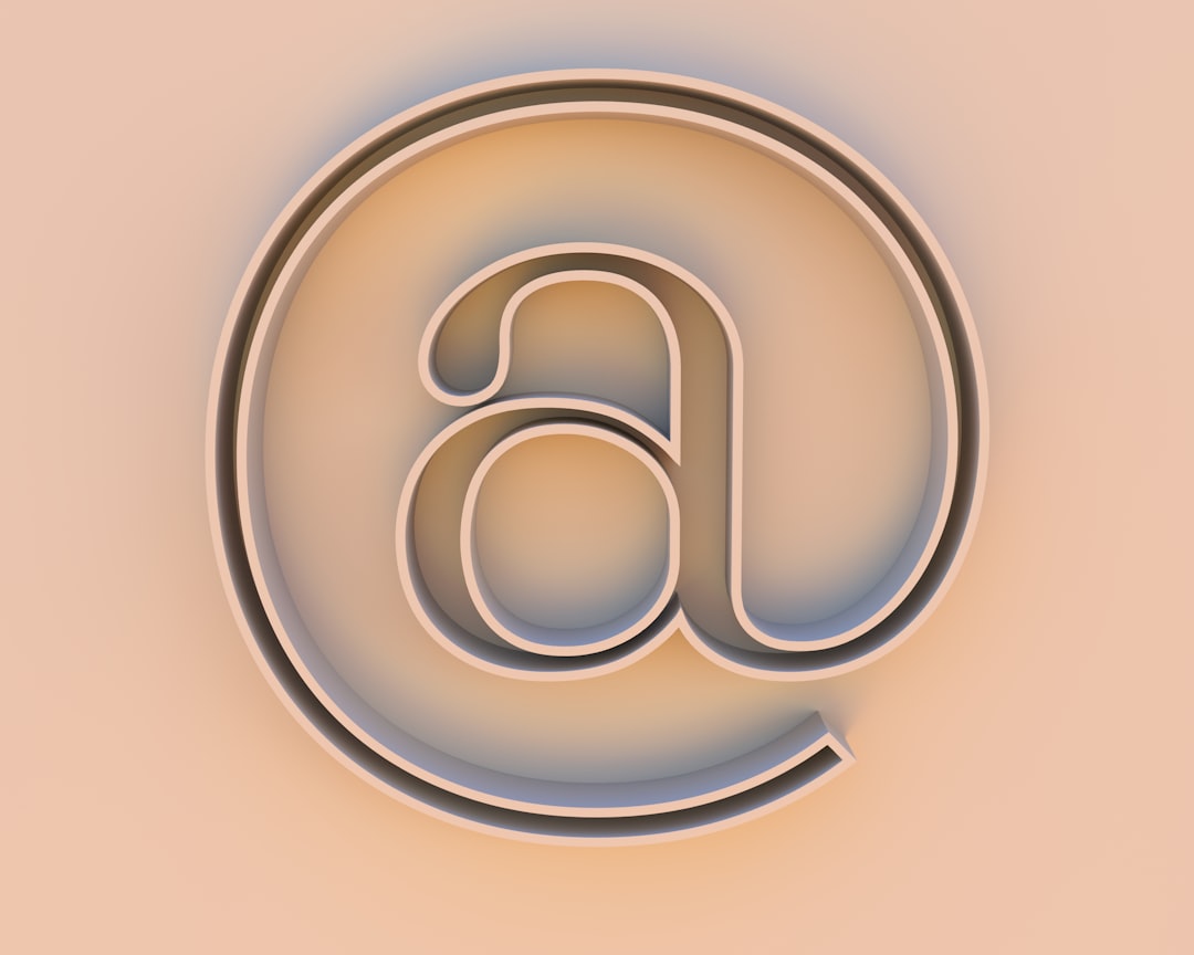Photo by Buddha Elemental 3D An "at" symbol on a beige background.